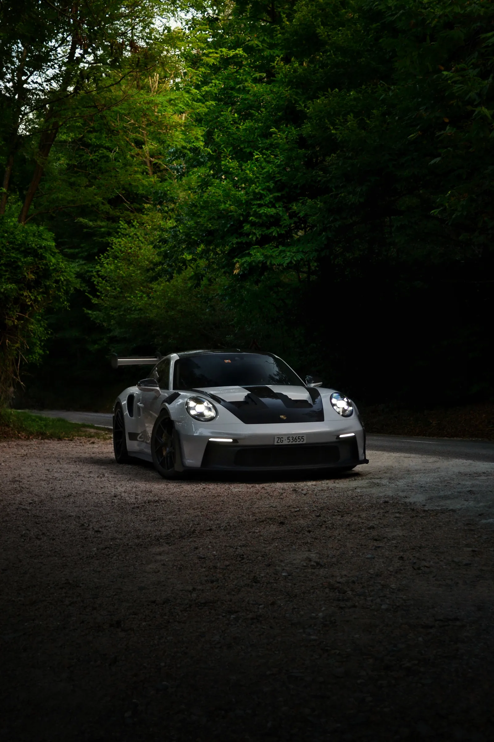 Grey Porsche 911 GT3 RS on a forest road