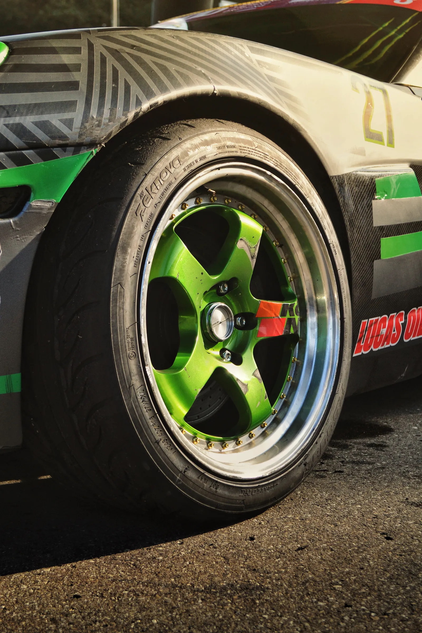 Close-up of a green alloy wheel on a race-livery car